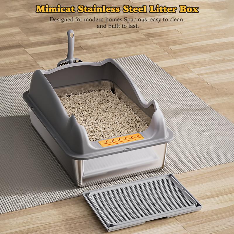 Large stainless steel cat litter box on floor mat.